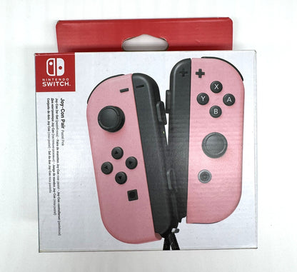 Verpackung eines Nintendo Switch Joy-Con Paars in Rosa. Die Verpackung zeigt die beiden Controller – links rosa, rechts rosa – auf weißem Hintergrund mit rotem Kopfteil.