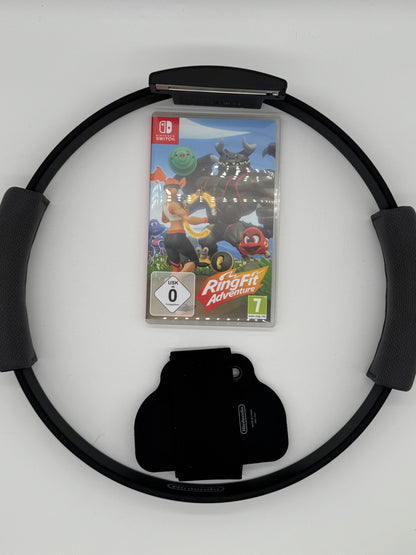 Verpackung von „Ring Fit Adventure“ für Nintendo Switch. Im Vordergrund eine sportliche Spielfigur mit einem Trainingsring (Ring-Con), der an einen Fitnessreifen erinnert. Im Hintergrund eine bunte Fantasiewelt mit Monstern. Ein Fitnessspiel, das körperliche Aktivität mit Rollenspiel-Elementen kombiniert. USK 0.